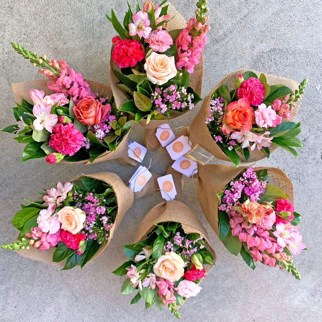 Multiple small flower bunches prepared for a team delivery in Sydney