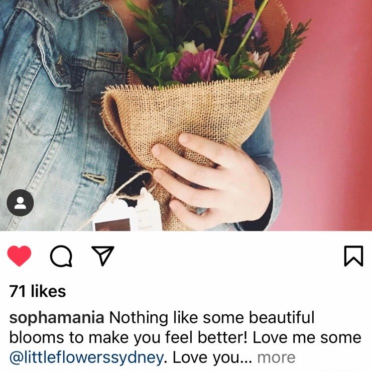 Customer holding flowers that helped them feel better during recovery